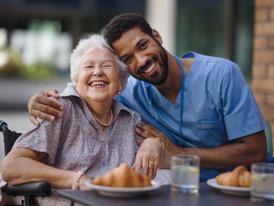 A caregiver providing companion care to a client in their home