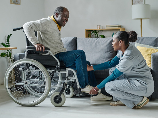 A caregiver providing personal care to a client in their home